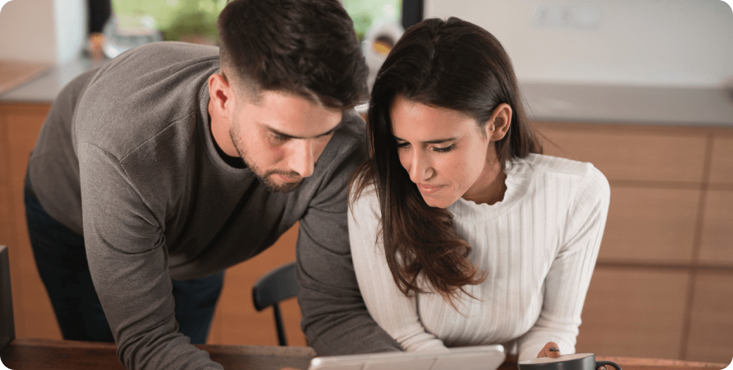 Newlywed couple reviewing financial documents together