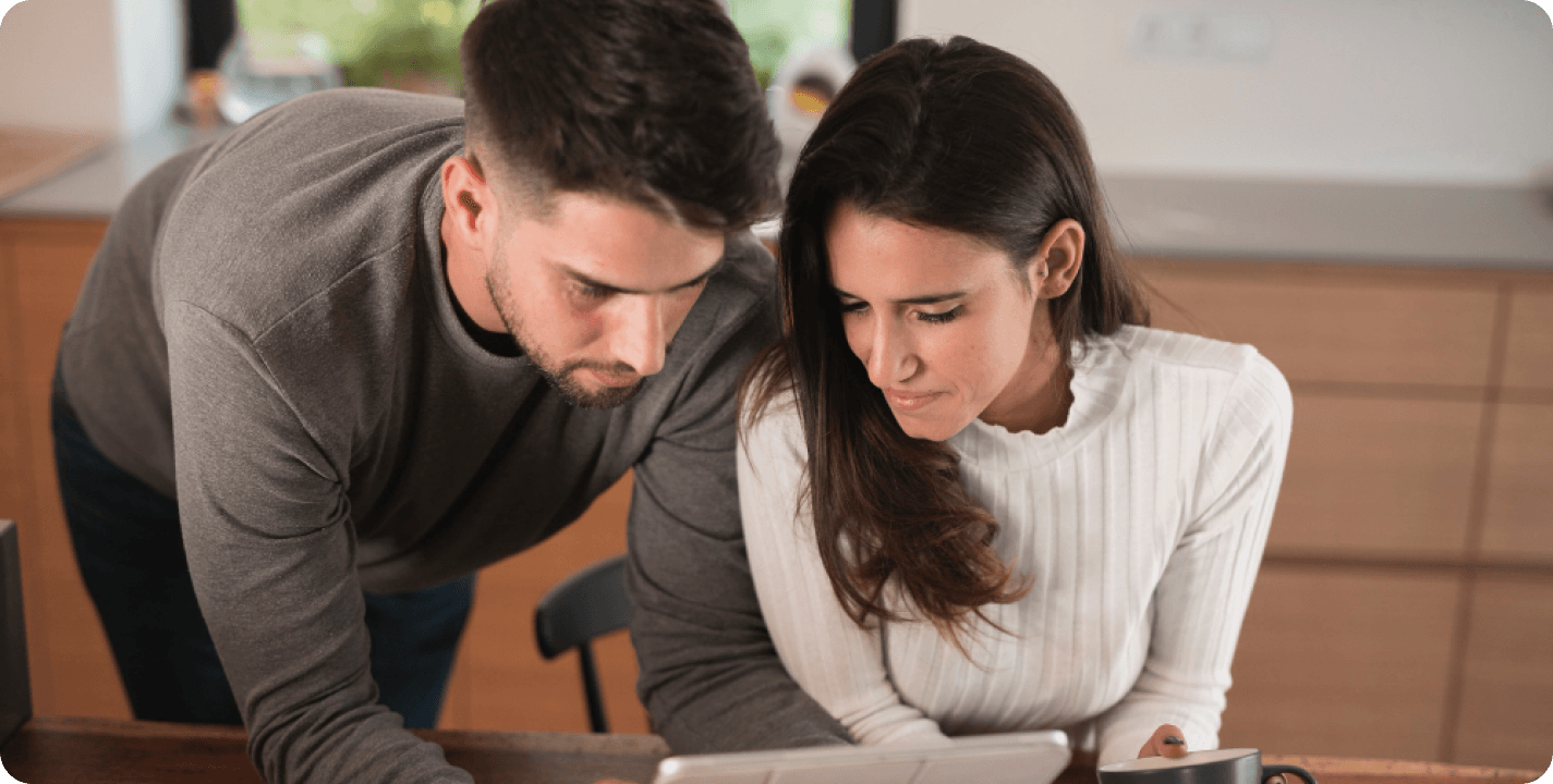 Newlywed couple reviewing financial documents together