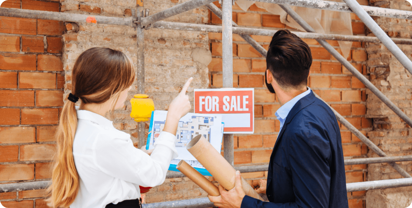 Real estate agents discussing property investment